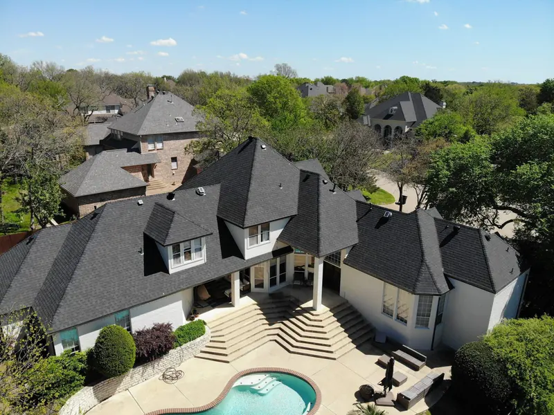 Large two-story home with a new dark impact-resistant shingle roof