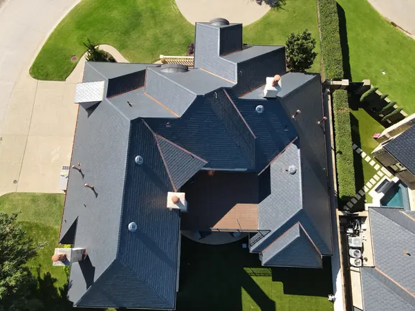 Stucco home with an EcoStar synthetic slate roof, copper valleys and copper vent pipes