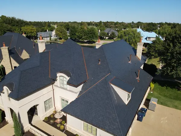 Close-up of EcoStar slate with copper valleys, vent pipes and eyebrow dormers